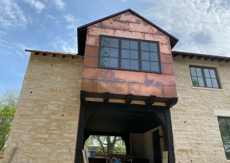 Copper metal panel facade on a stone building for Skylight Installation in Saginaw