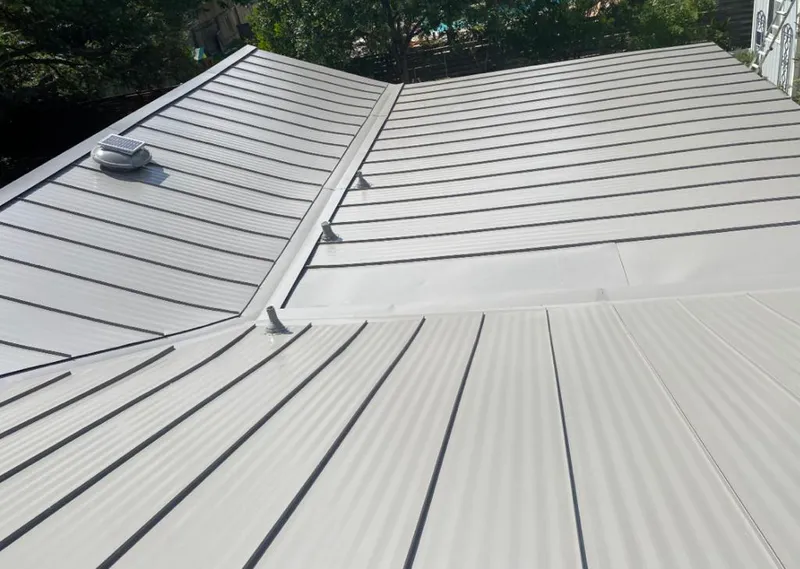 Solar attic fan installed on a metal roof for Roof Ventilation in Saginaw